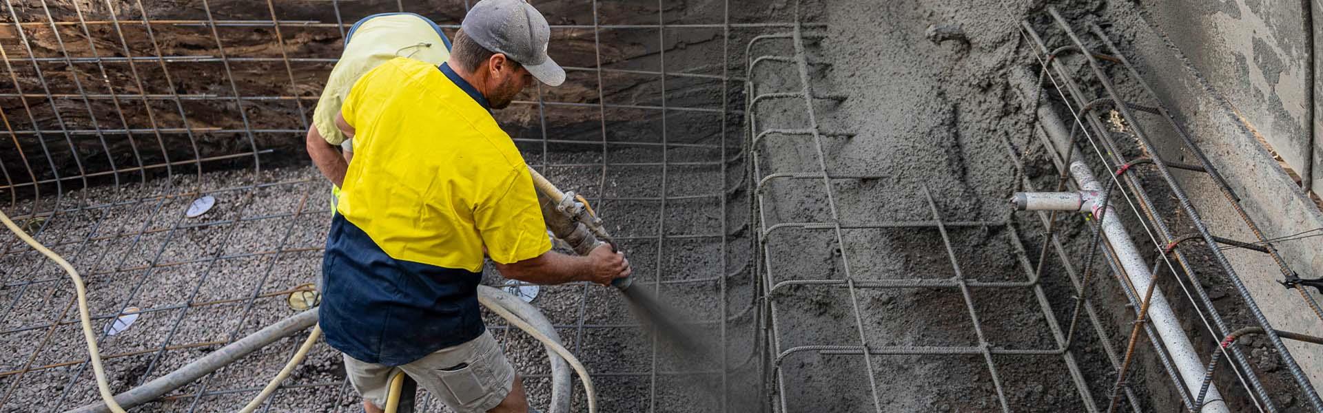 person spraying concrete